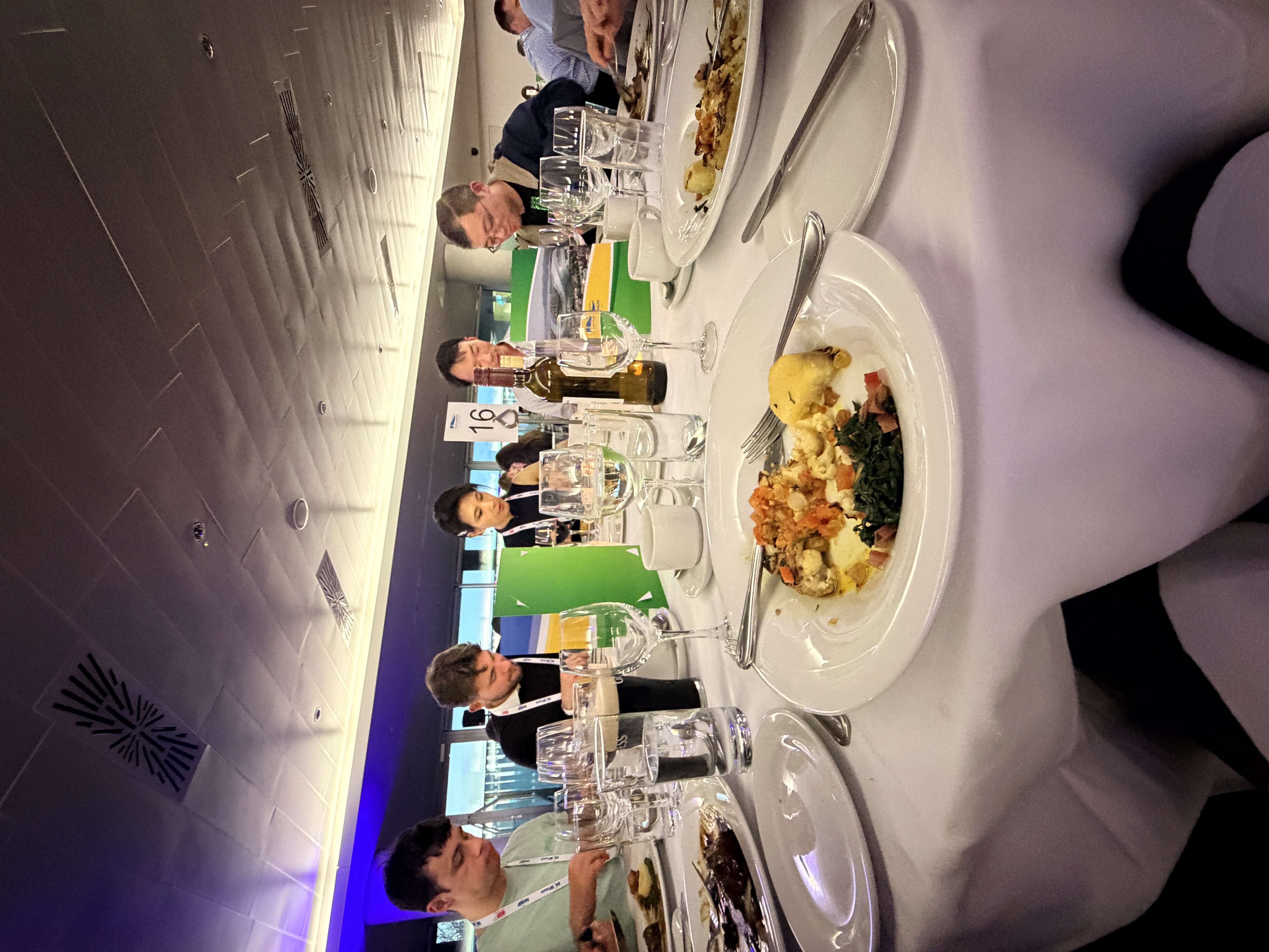 Conference attendees seated around a dinner table.